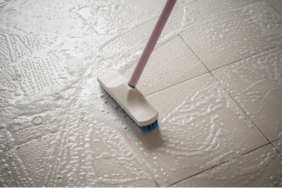 Scrubbing tile flooring during a deep clean